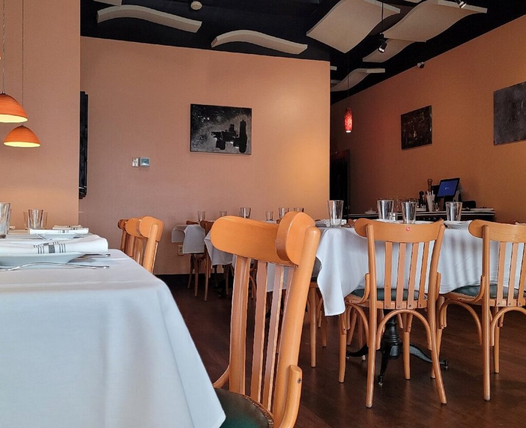 Inviting Italian restaurant dining room with neatly arranged tables and chairs for family dining in Greensboro NC.