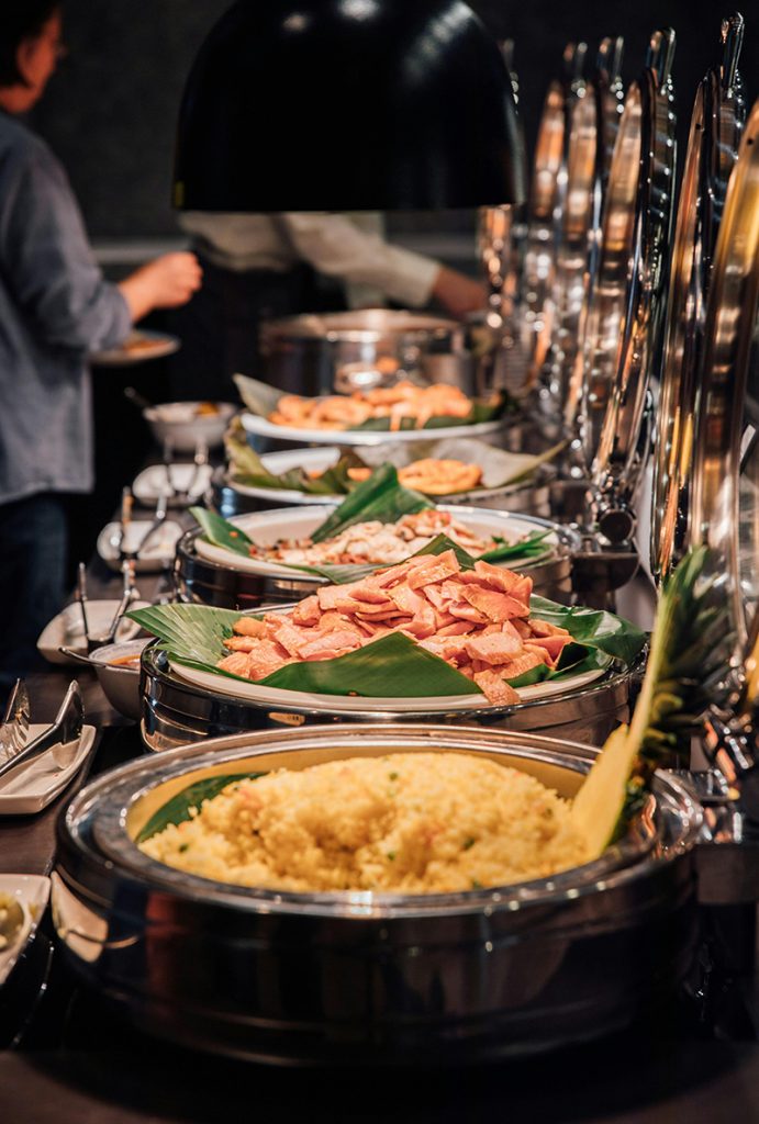 Buffet-style dinner spread with salads, meats, and desserts for a special occasion