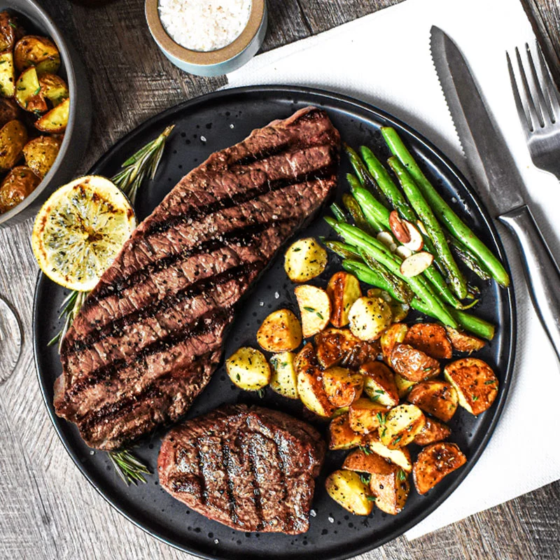 Premium steak with roasted potatoes and steamed green beans at an Italian steakhouse in Greensboro NC